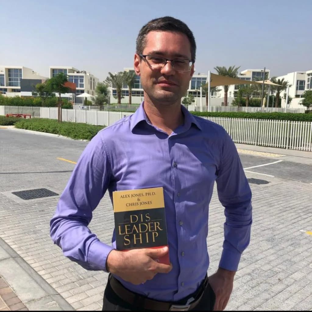 A reader holding a copy of DISLEADERSHIP